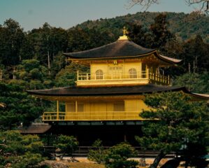 A stunning view of the Golden Pavilion surrounded by lush greenery in Kyoto, Japan.