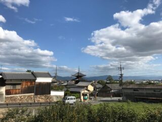 Scenic view of a traditional Japanese town featuring a pagoda under a clear blue sky.