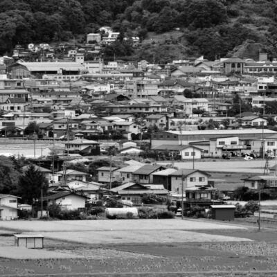 Black and white view of Suwa town showcasing architecture and landscape.